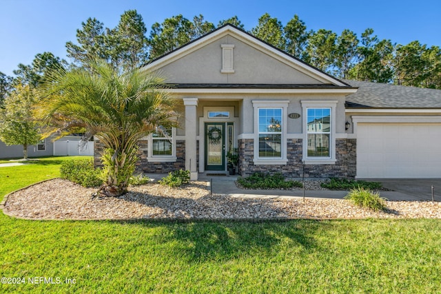 view of front of property featuring a front lawn and a garage