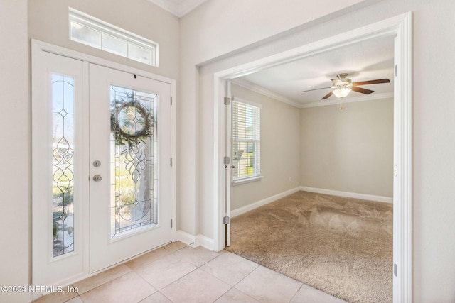 foyer entrance featuring light colored carpet, ceiling fan, and ornamental molding