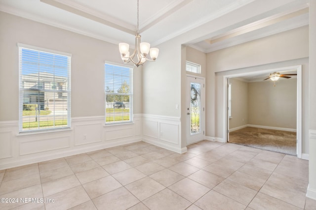 tiled foyer featuring a tray ceiling, ceiling fan with notable chandelier, and ornamental molding