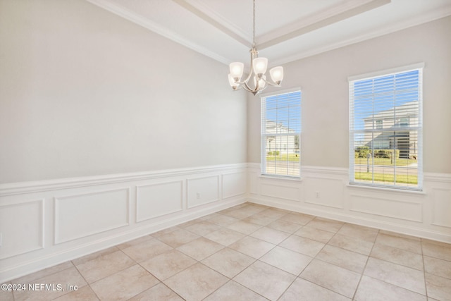 unfurnished room featuring a tray ceiling, crown molding, light tile patterned floors, and an inviting chandelier