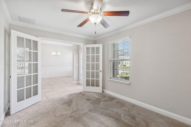 carpeted empty room featuring ceiling fan with notable chandelier, french doors, a textured ceiling, and crown molding