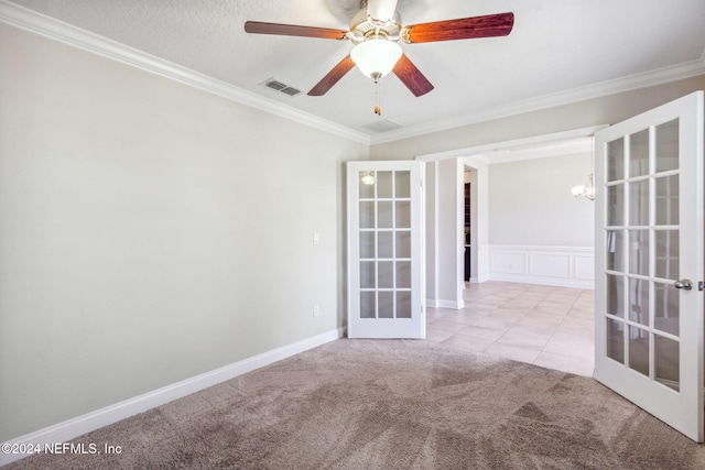 carpeted empty room featuring ceiling fan with notable chandelier, french doors, a textured ceiling, and ornamental molding