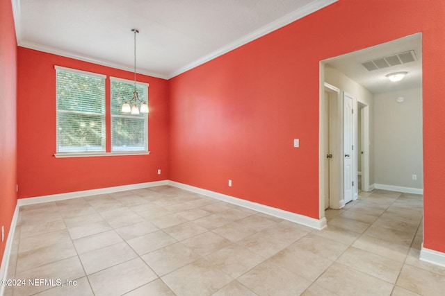 empty room with light tile patterned flooring, ornamental molding, and a notable chandelier