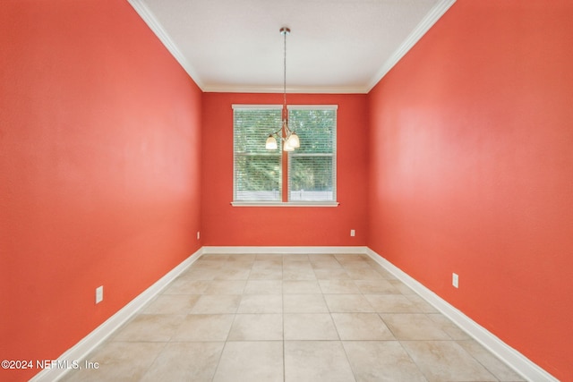 unfurnished dining area featuring tile patterned floors, ornamental molding, and a chandelier