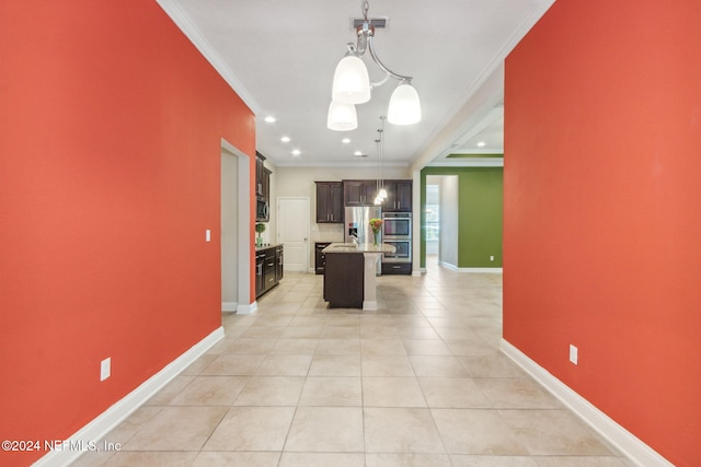 kitchen featuring stainless steel appliances, crown molding, a center island with sink, and hanging light fixtures