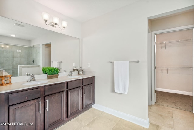 bathroom featuring tile patterned flooring, vanity, and a shower with shower door