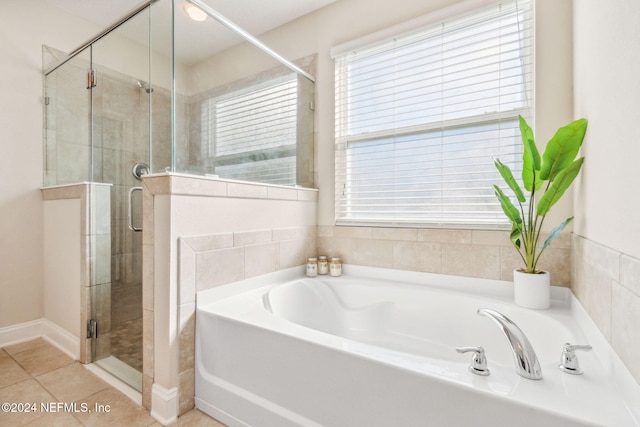 bathroom featuring separate shower and tub, tile patterned floors, and a healthy amount of sunlight