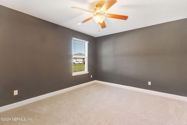 carpeted empty room featuring a textured ceiling and ceiling fan