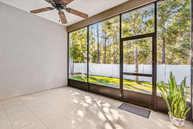 unfurnished sunroom with ceiling fan and wood ceiling