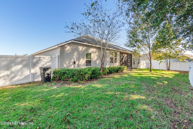 rear view of property with a yard