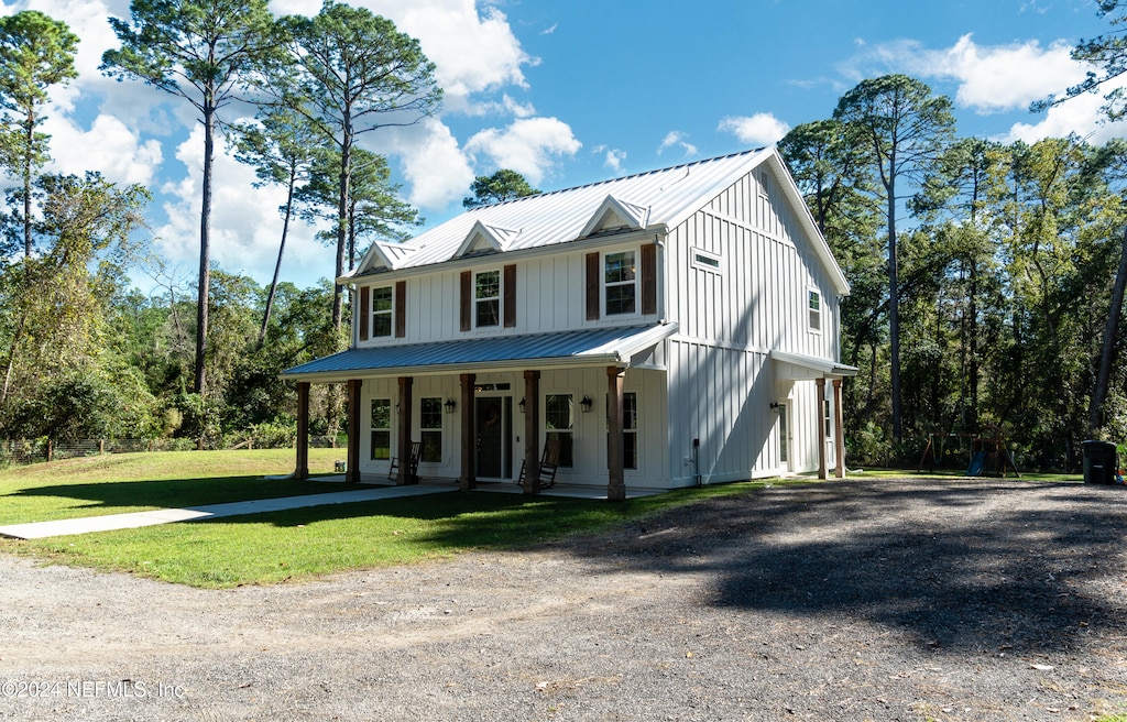 view of front of house with covered porch and a front yard