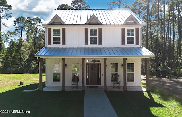 view of front facade featuring covered porch and a front yard