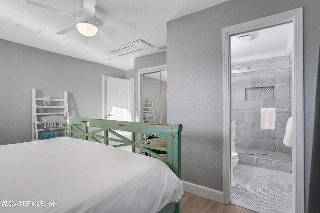 bedroom featuring hardwood / wood-style floors, connected bathroom, a closet, and ceiling fan