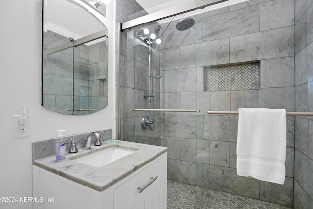 bathroom with a shower with door and vanity