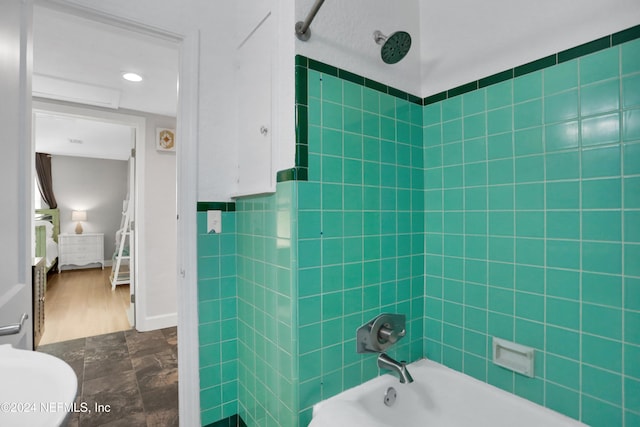 bathroom featuring tiled shower / bath combo and hardwood / wood-style flooring