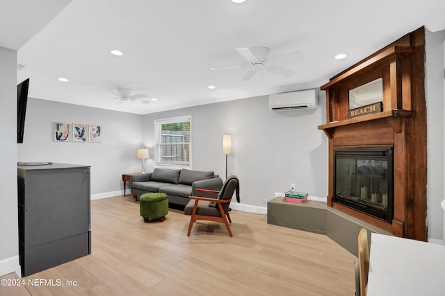 living room featuring light hardwood / wood-style flooring, a wall mounted AC, and ceiling fan