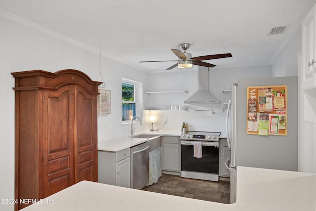 kitchen featuring wall chimney range hood, crown molding, sink, gray cabinets, and stainless steel appliances