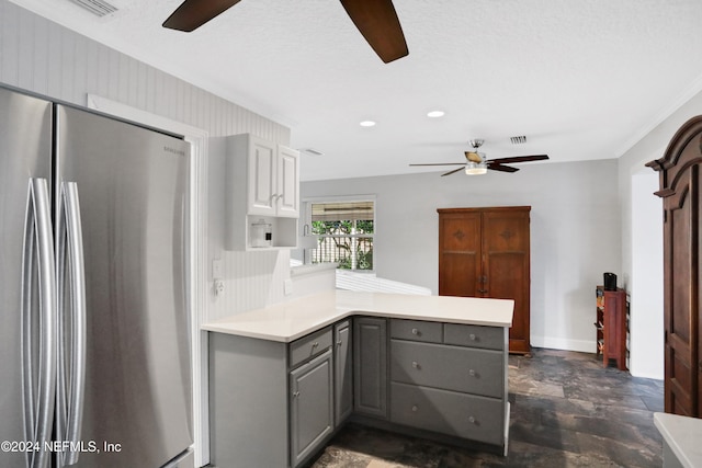 kitchen featuring gray cabinetry, backsplash, ornamental molding, kitchen peninsula, and stainless steel refrigerator