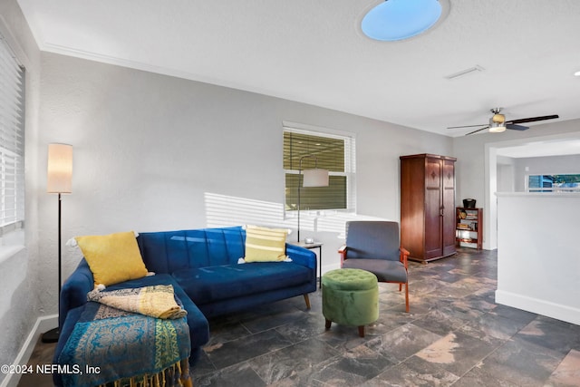 living room featuring ceiling fan and ornamental molding