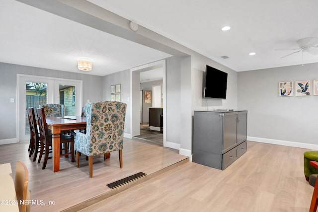 dining room featuring ceiling fan, light wood-type flooring, and french doors