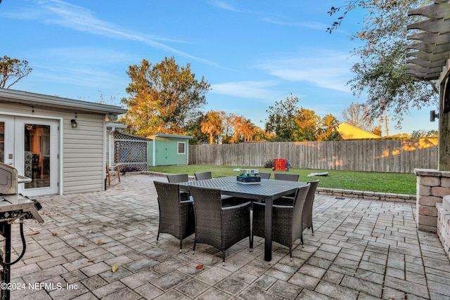 view of patio / terrace with a shed