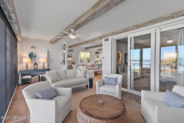 living room with beam ceiling, ceiling fan, a water view, and wood-type flooring