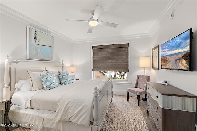 bedroom with ceiling fan, ornamental molding, and light colored carpet