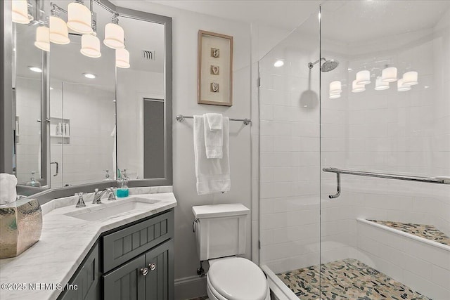 bathroom featuring an enclosed shower, vanity, and toilet