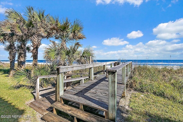 view of home's community featuring a water view and a view of the beach