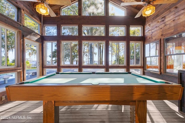 rec room featuring high vaulted ceiling, ceiling fan, wooden walls, and pool table