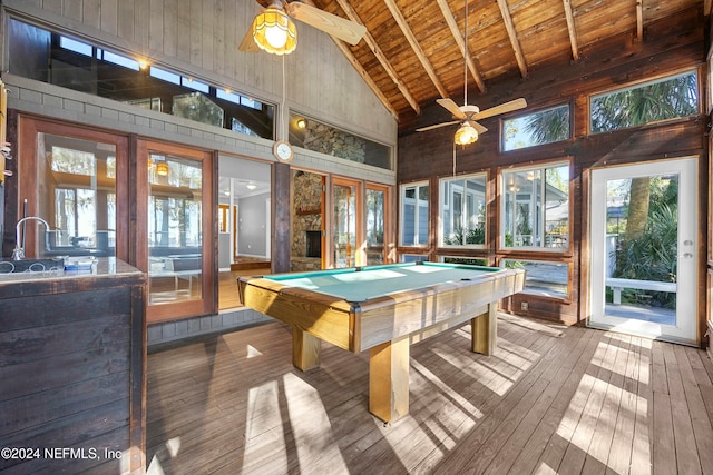 game room with beamed ceiling, high vaulted ceiling, a wealth of natural light, and billiards