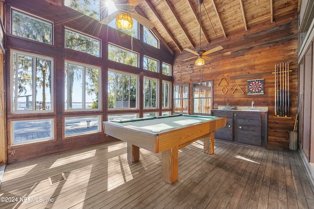 rec room featuring beam ceiling, hardwood / wood-style flooring, wood walls, and billiards