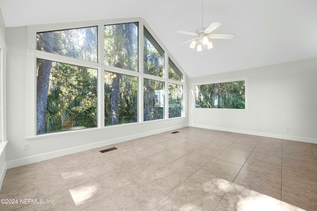 unfurnished sunroom featuring a wealth of natural light, lofted ceiling, and ceiling fan