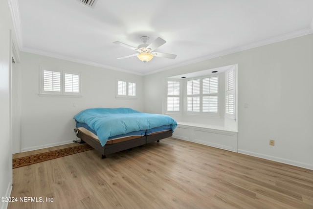 bedroom with ceiling fan, ornamental molding, and light wood-type flooring