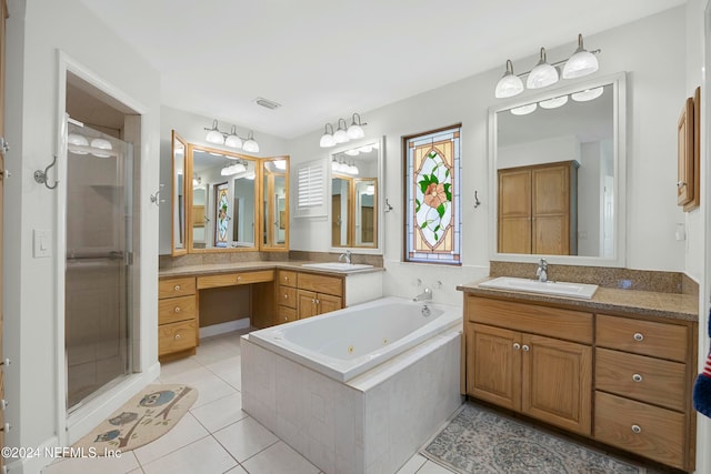 bathroom with tile patterned floors, vanity, and shower with separate bathtub