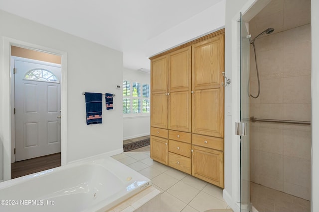 bathroom with tile patterned floors, plenty of natural light, and independent shower and bath