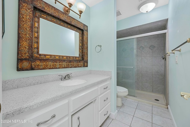 bathroom with toilet, vanity, tile patterned floors, and a shower with door