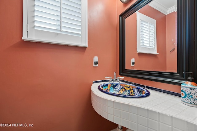 bathroom featuring a wealth of natural light and crown molding