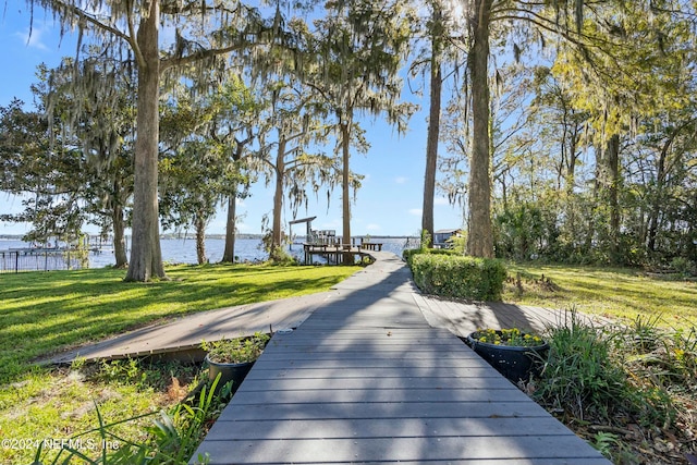 view of home's community featuring a yard and a water view