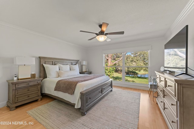 bedroom featuring multiple windows, crown molding, light hardwood / wood-style flooring, and ceiling fan