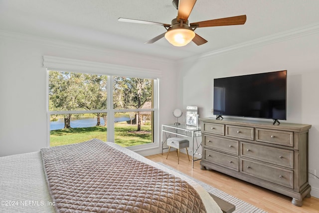 bedroom with light hardwood / wood-style floors, ceiling fan, and crown molding