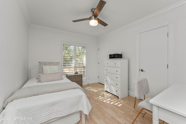 bedroom featuring hardwood / wood-style flooring, ceiling fan, and ornamental molding