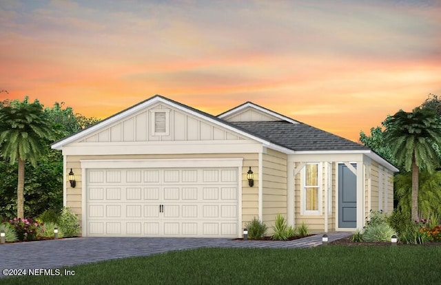 view of front facade featuring a lawn and a garage