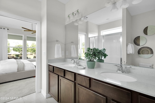 bathroom featuring tile patterned flooring, vanity, and a shower with shower door