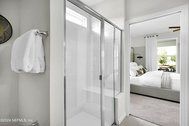 bathroom featuring plenty of natural light and a shower with door