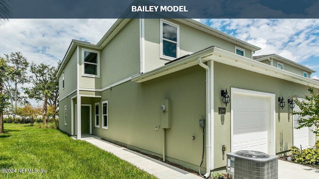 view of home's exterior with a yard, a garage, and cooling unit