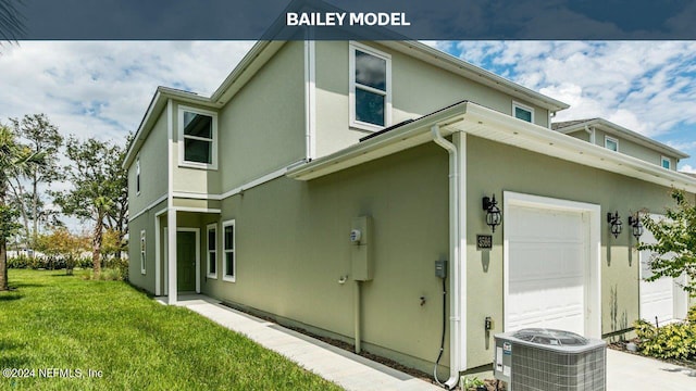 view of home's exterior with a yard, a garage, and cooling unit