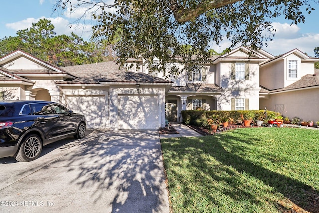 view of front of property with a front yard and a garage