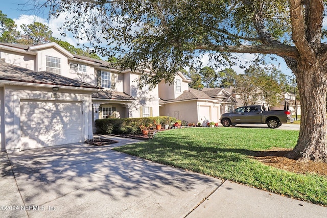 front facade with a front lawn and a garage