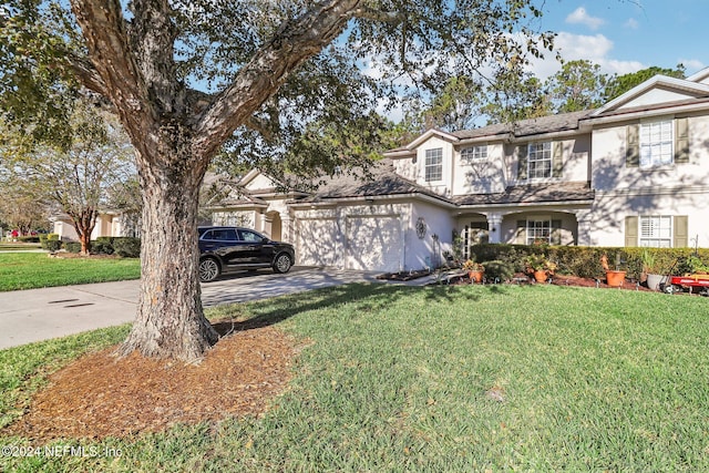 view of front facade with a garage and a front lawn